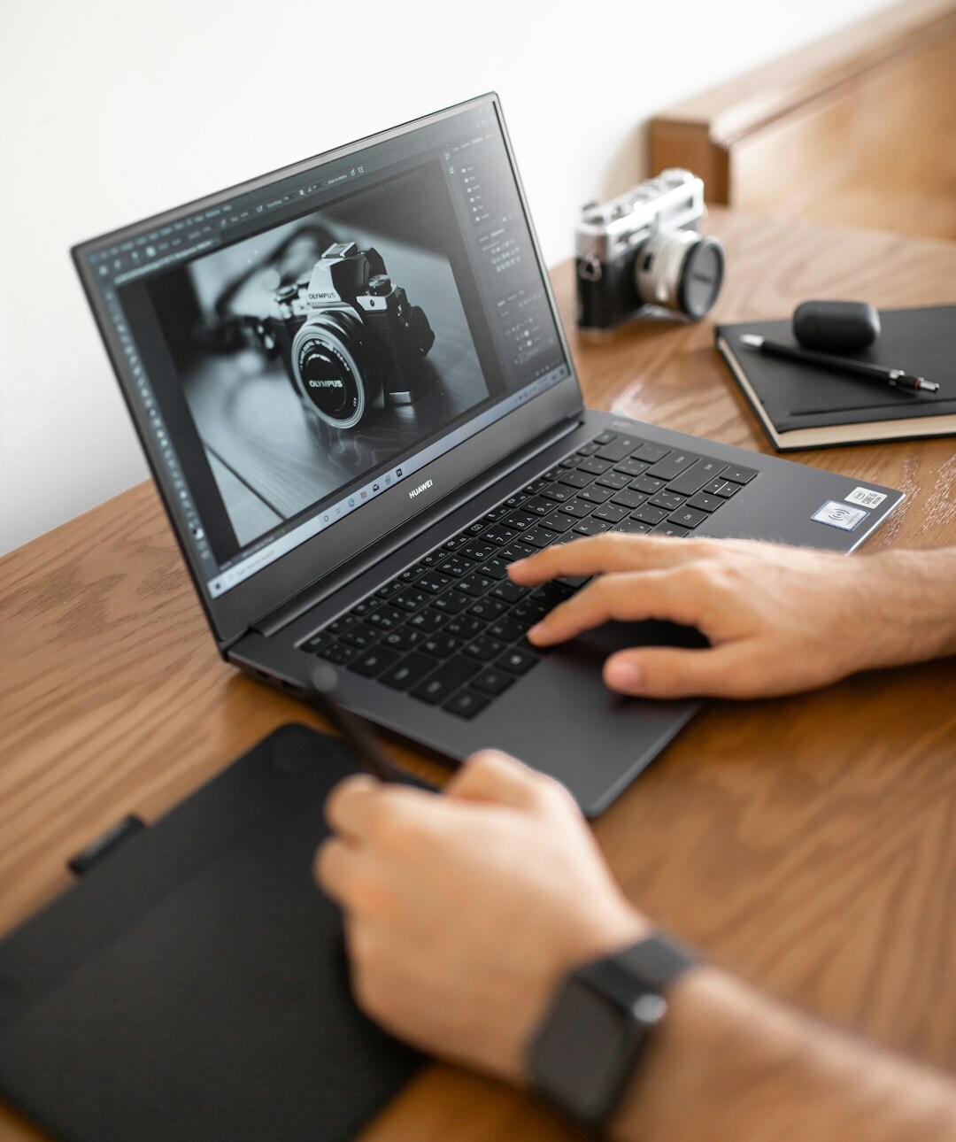 Photo editor reviewing documentary photographs on laptop